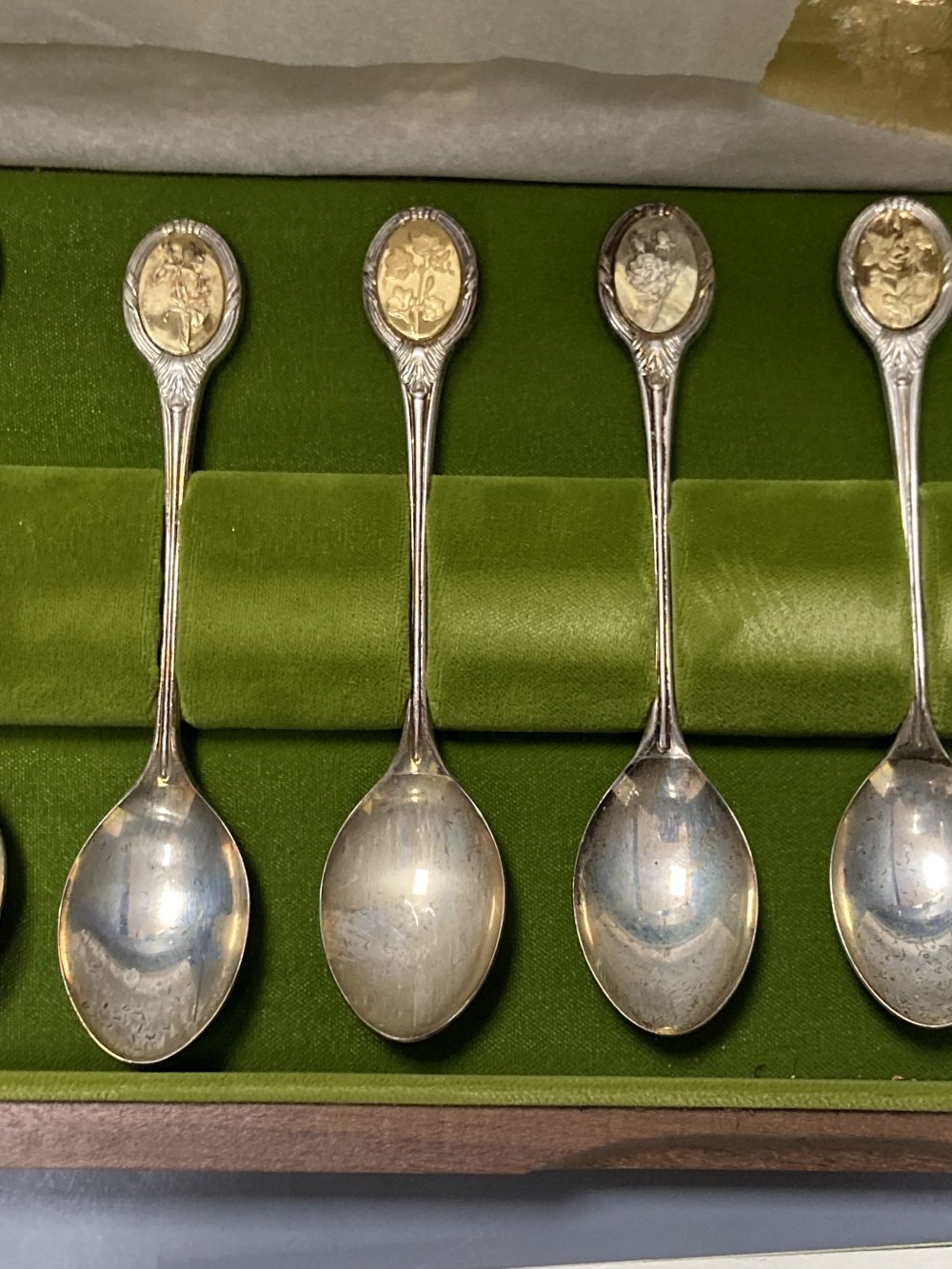 A modern cased set of twelve parcel gilt silver Royal Horticultural Society Flower Spoons by John Pinches,